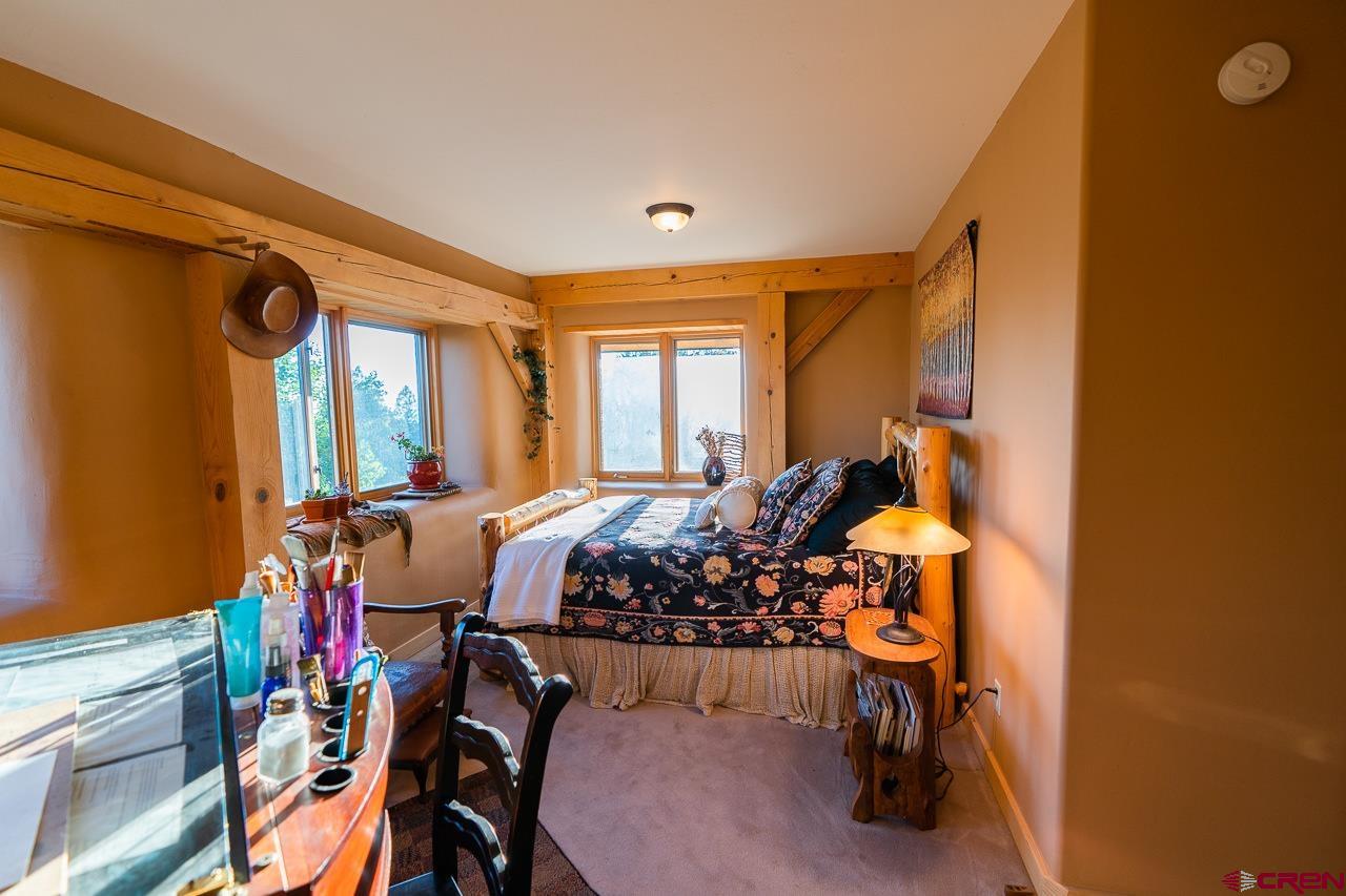 200 Longview Lane Bayfield, CO 81122 - Photo 19 of 33 a bed room with furniture and a window