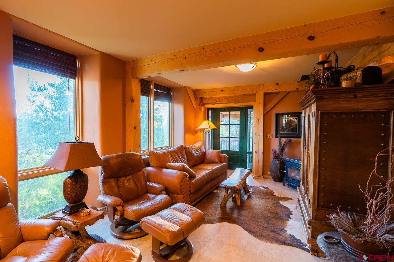 200 Longview Lane Bayfield, CO 81122 - Photo 23 of 33 a living room with furniture fireplace and a large window