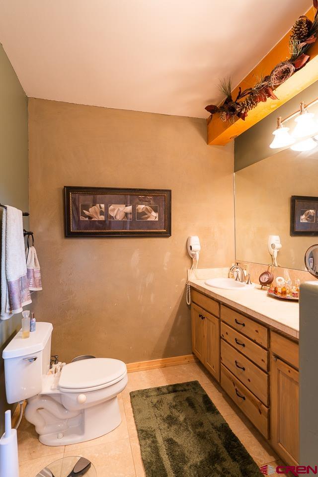 200 Longview Lane Bayfield, CO 81122 - Photo 10 of 33 a bathroom with a toilet a sink and mirror