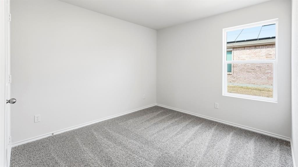 3519 Spring Time Street Forney, TX 75126 - Photo 11 of 37 Neutral-toned interior room featuring light gray walls, gray patterned carpet, and white trim