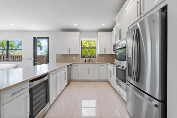 a kitchen with stainless steel appliances a sink and a stove top oven