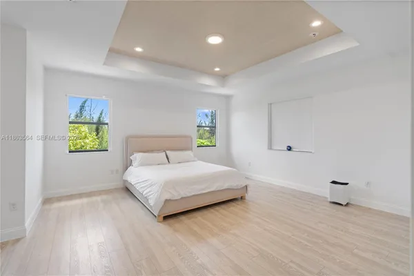 a bedroom with a bed and a painting on the wall