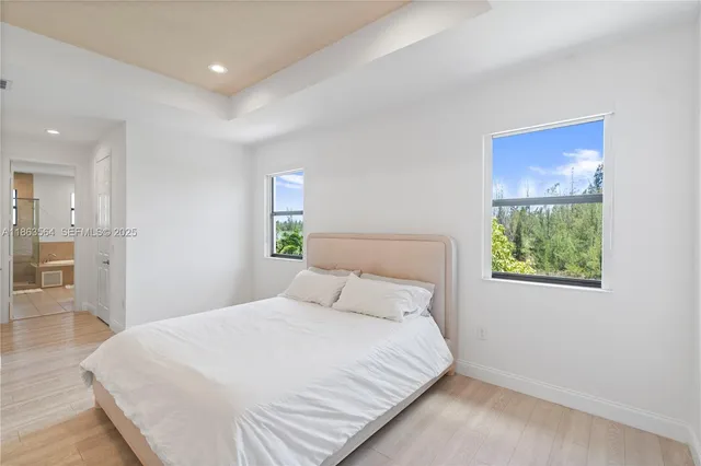 a bathroom with a granite countertop tub double vanity sink and mirror