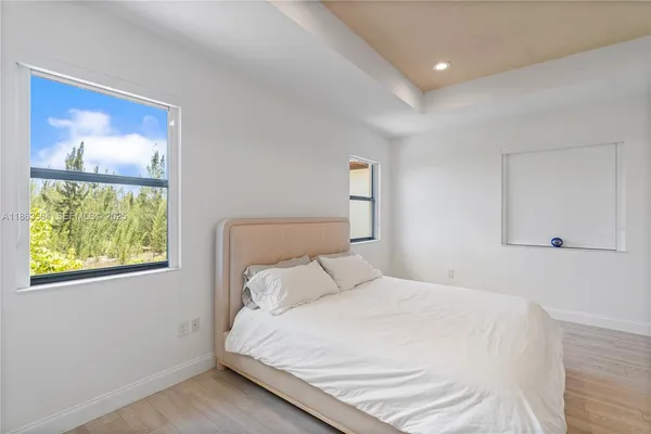a spacious bathroom with a granite countertop sink mirror and bathtub