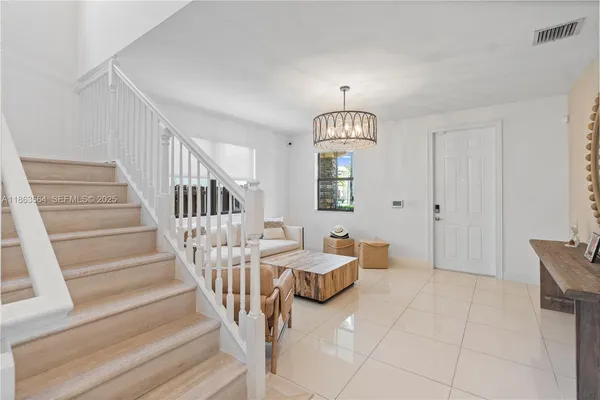 a view of a livingroom with furniture and staircase