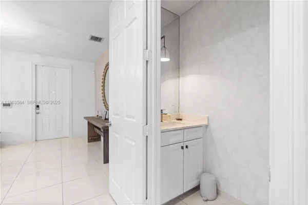 a bathroom with a double vanity sink and a mirror