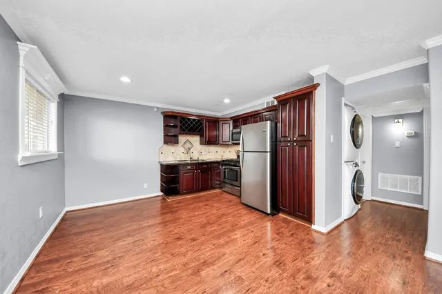 a kitchen with stainless steel appliances granite countertop a refrigerator stove top oven and sink