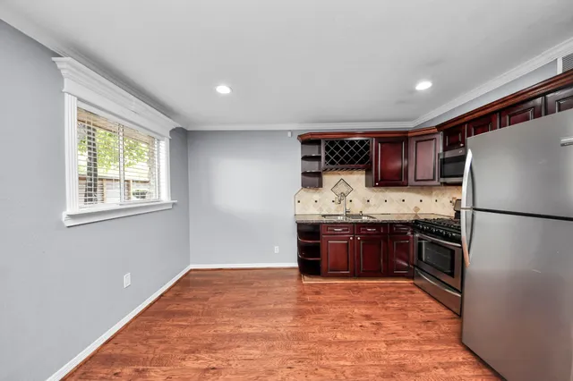 a kitchen with stainless steel appliances granite countertop a refrigerator stove and oven