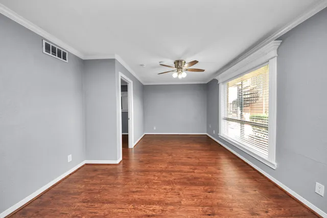 wooden floor in an empty room with a window