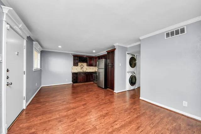 a view of empty room with wooden floor