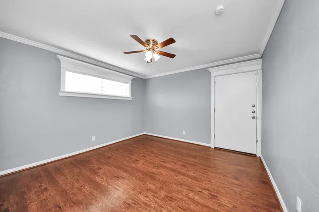 wooden floor in an empty room with a window