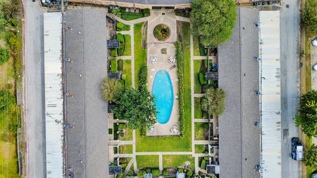 a view of an apartment with a backyard