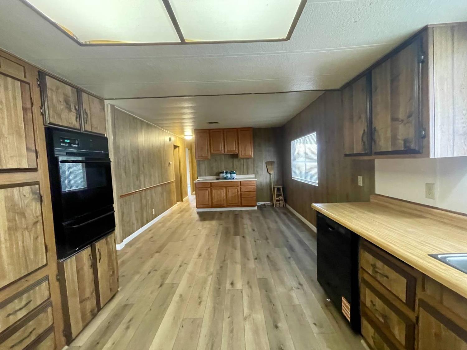 3901 Lake Road, Unit 111 West Sacramento, CA 95691 - Photo 11 of 16 a view of a kitchen with a sink and wooden floor