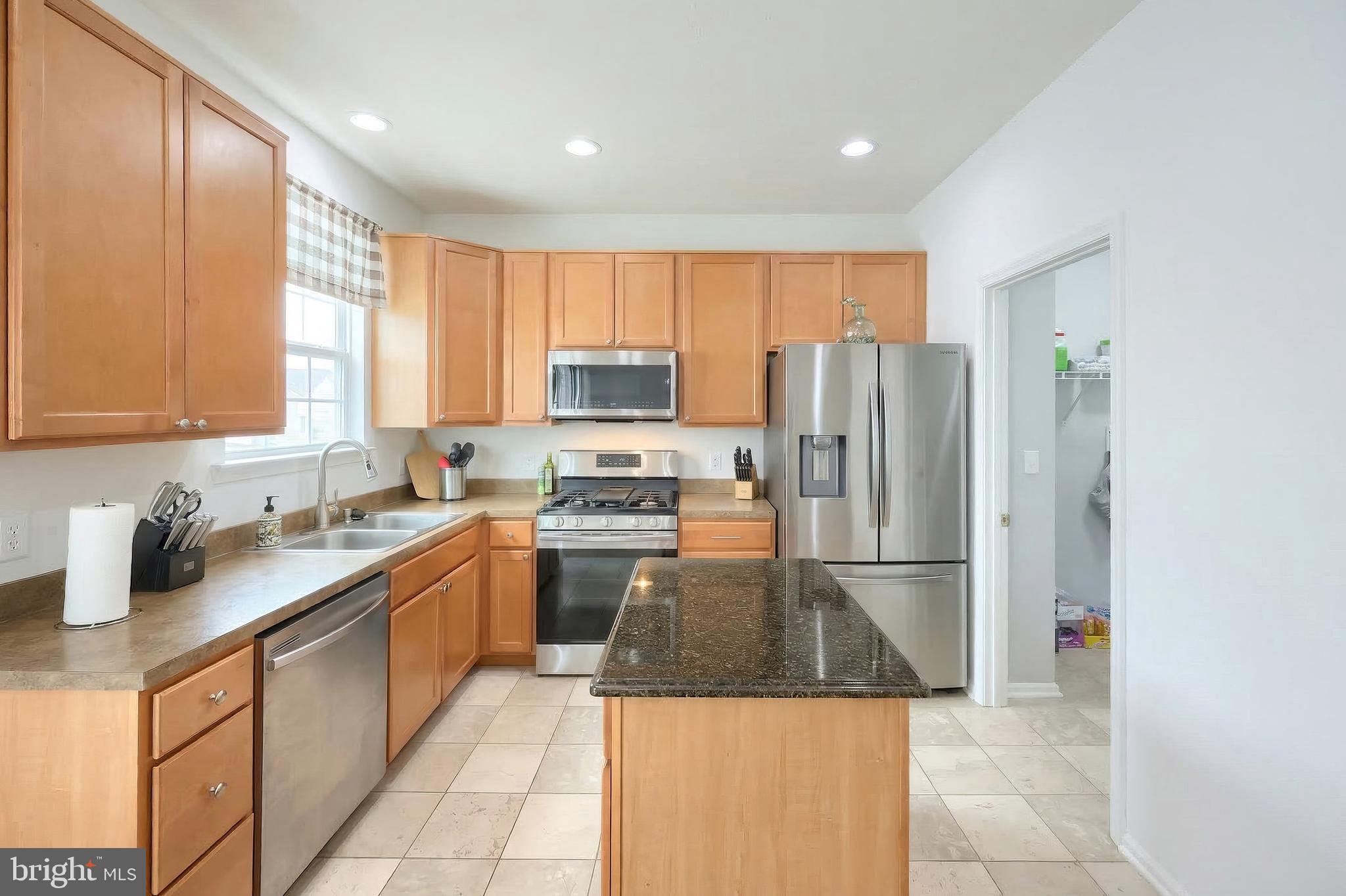 322 Cape Climb York, PA 17408 - Photo 20 of 31 a kitchen with a refrigerator a sink and wooden cabinets