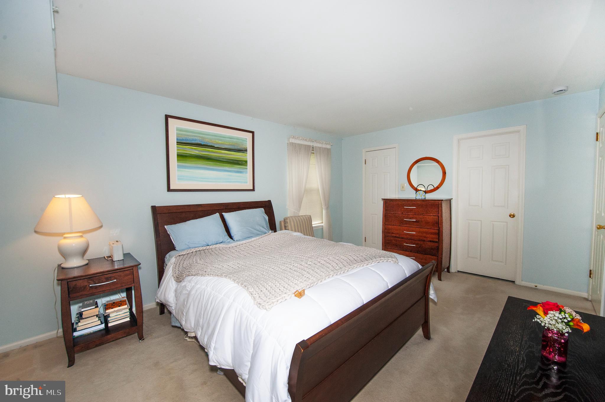 631 Washington Place Chesterbrook, PA 19087 - Photo 15 of 21 a spacious bedroom with a bed and a lamp on table