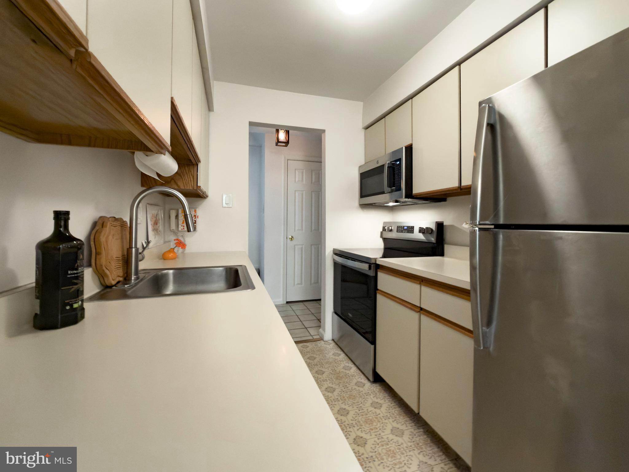 631 Washington Place Chesterbrook, PA 19087 - Photo 10 of 21 a kitchen with stainless steel appliances a refrigerator a sink a stove and cabinets