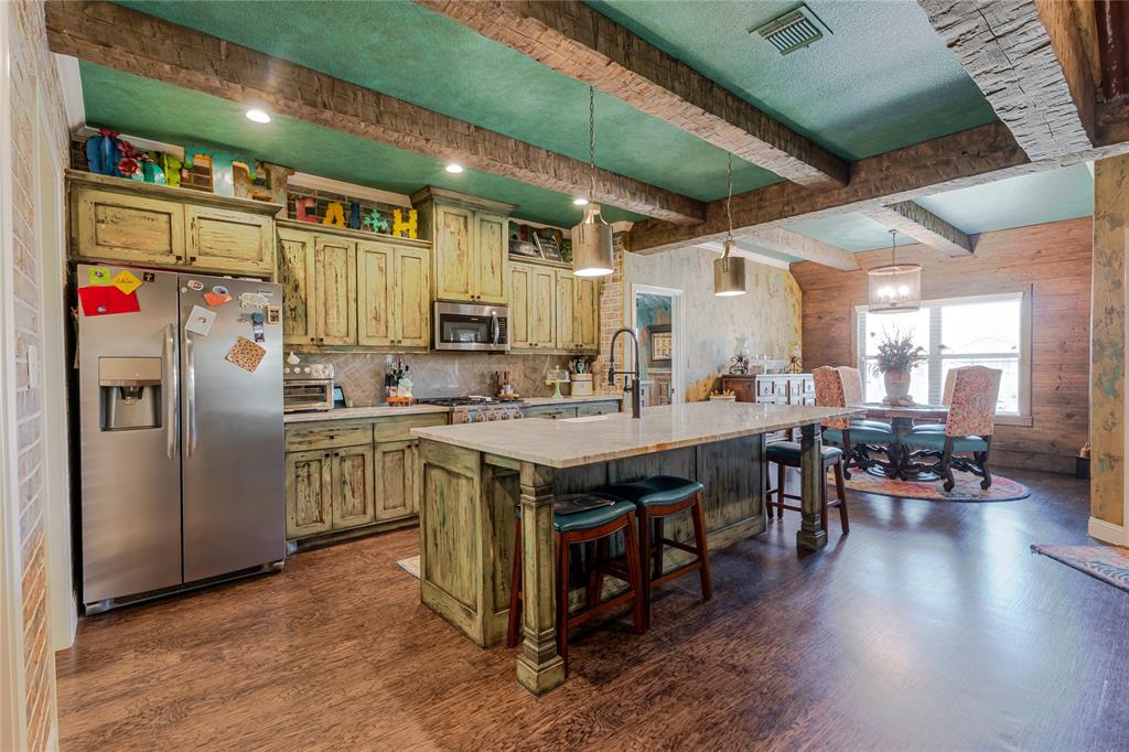 470 Wilson Bend Road Millsap, TX 76066 - Photo 11 of 39 a kitchen with stainless steel appliances granite countertop a sink a stove and a refrigerator