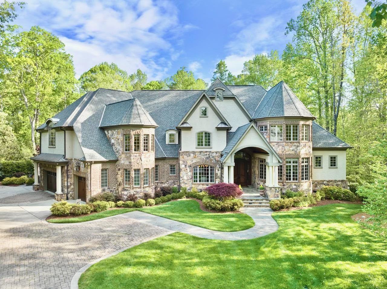 a front view of a house with a yard and porch