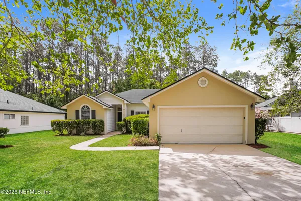an empty room with windows and fireplace