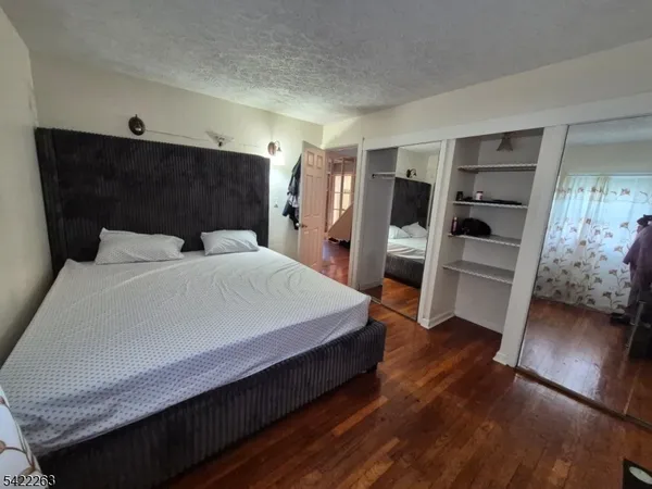 a bedroom with a bed and a view of closet