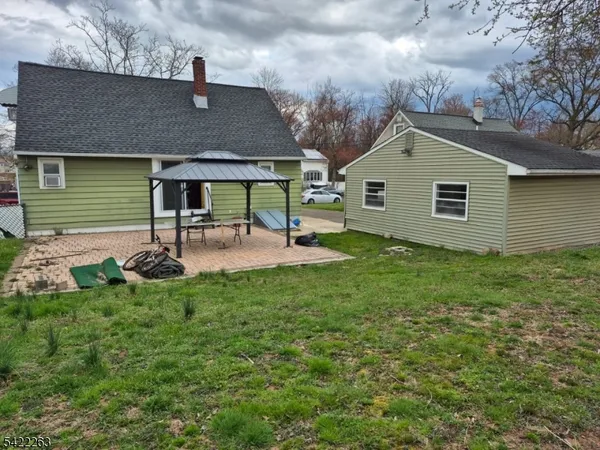 a backyard of a house with table and chairs