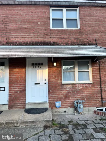 a view of a brick house with outdoor space