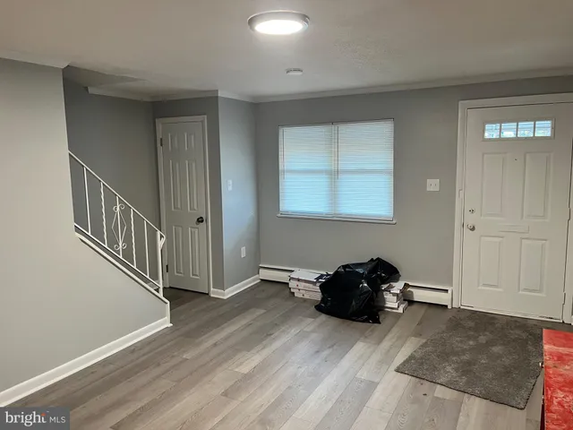 a hallway with a couch and a window