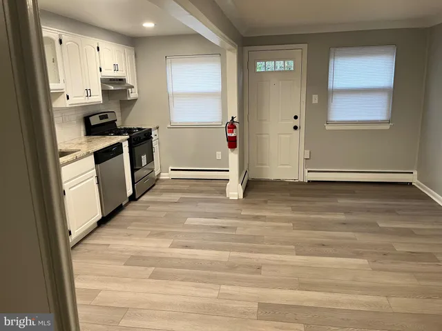a kitchen with granite countertop a refrigerator and a stove