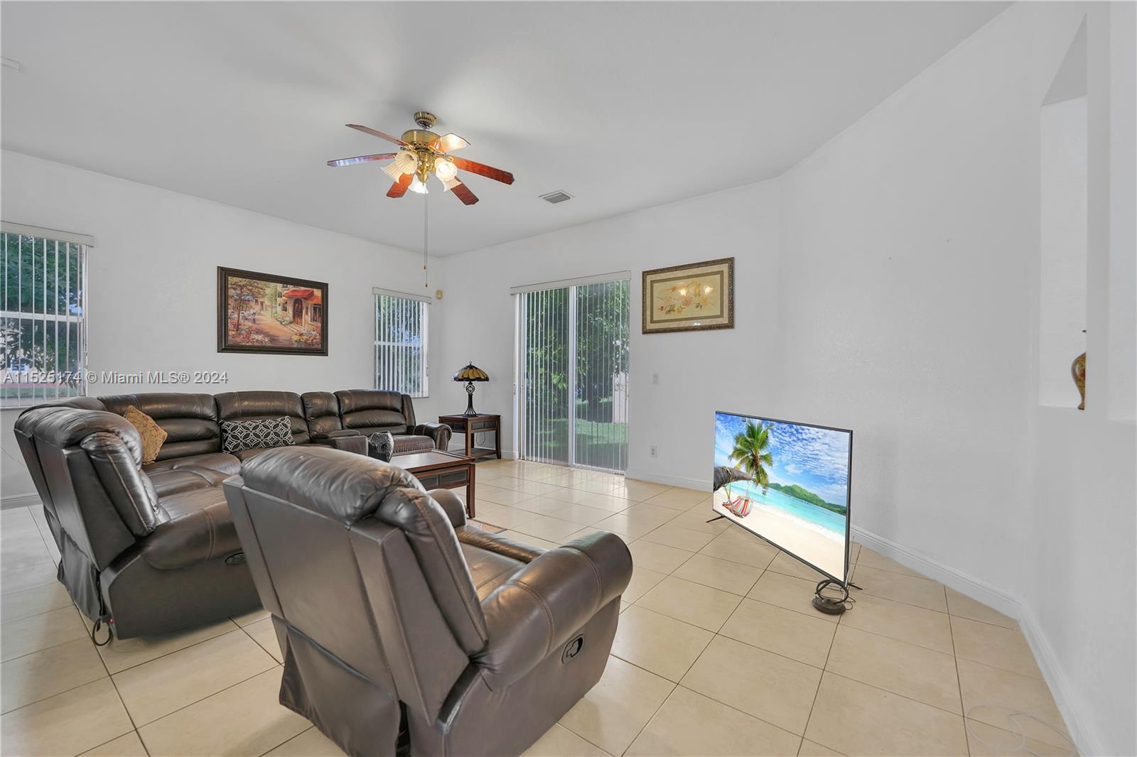 14093 Southwest 53rd Street Miramar, FL 33027 - Photo 24 of 45 a living room with furniture a computer on the desk and a window