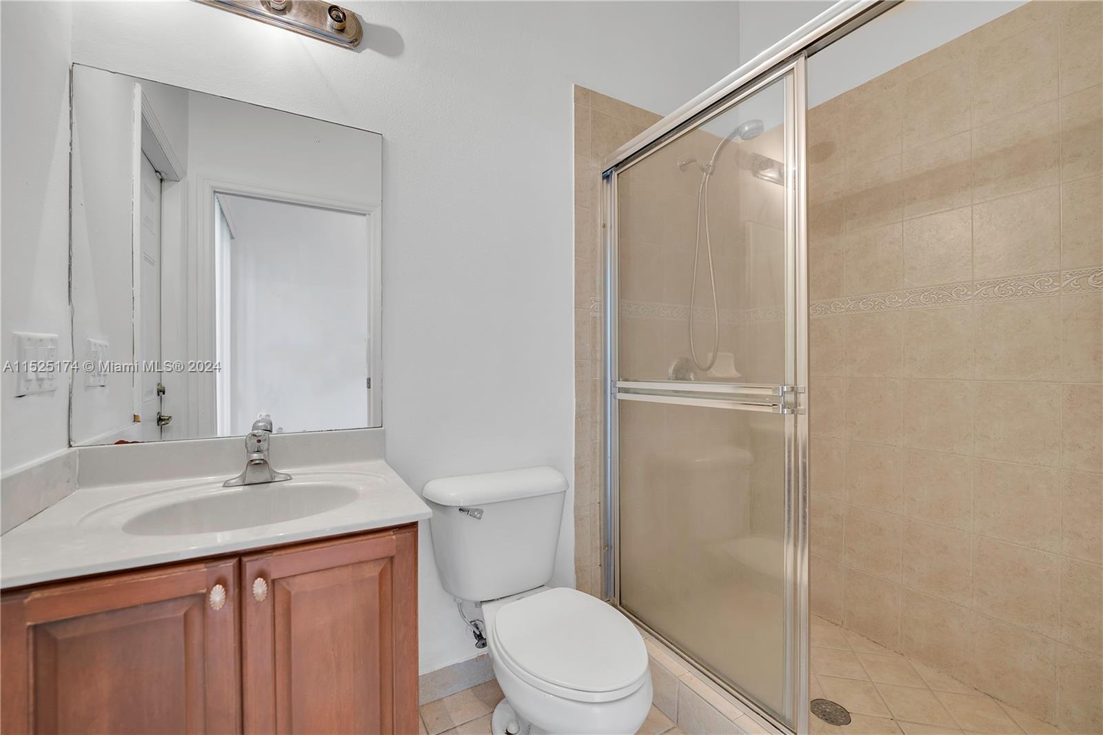 14093 Southwest 53rd Street Miramar, FL 33027 - Photo 28 of 45 a bathroom with a sink a toilet and shower