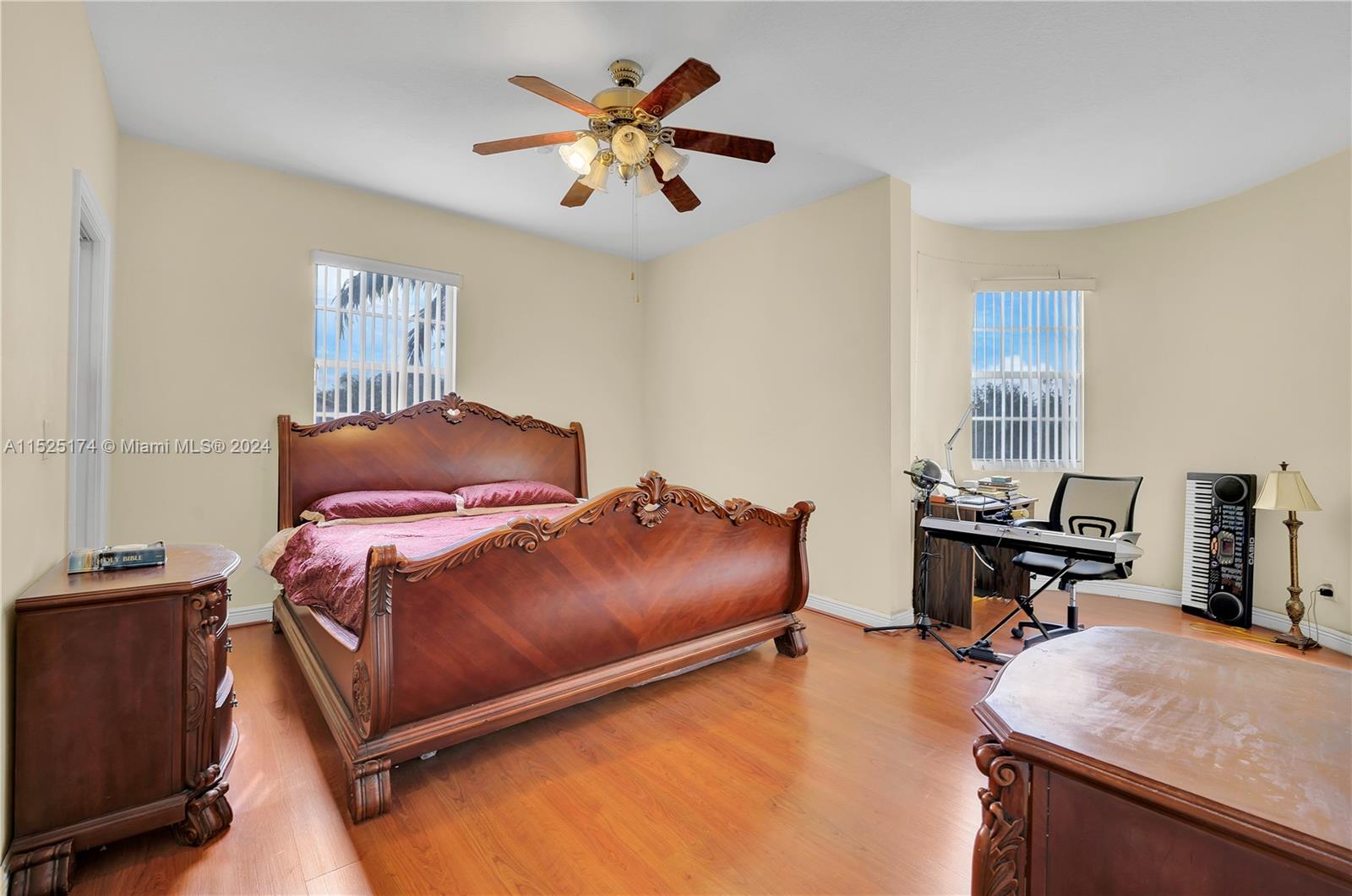 14093 Southwest 53rd Street Miramar, FL 33027 - Photo 35 of 45 a bedroom with a bed and a chandelier