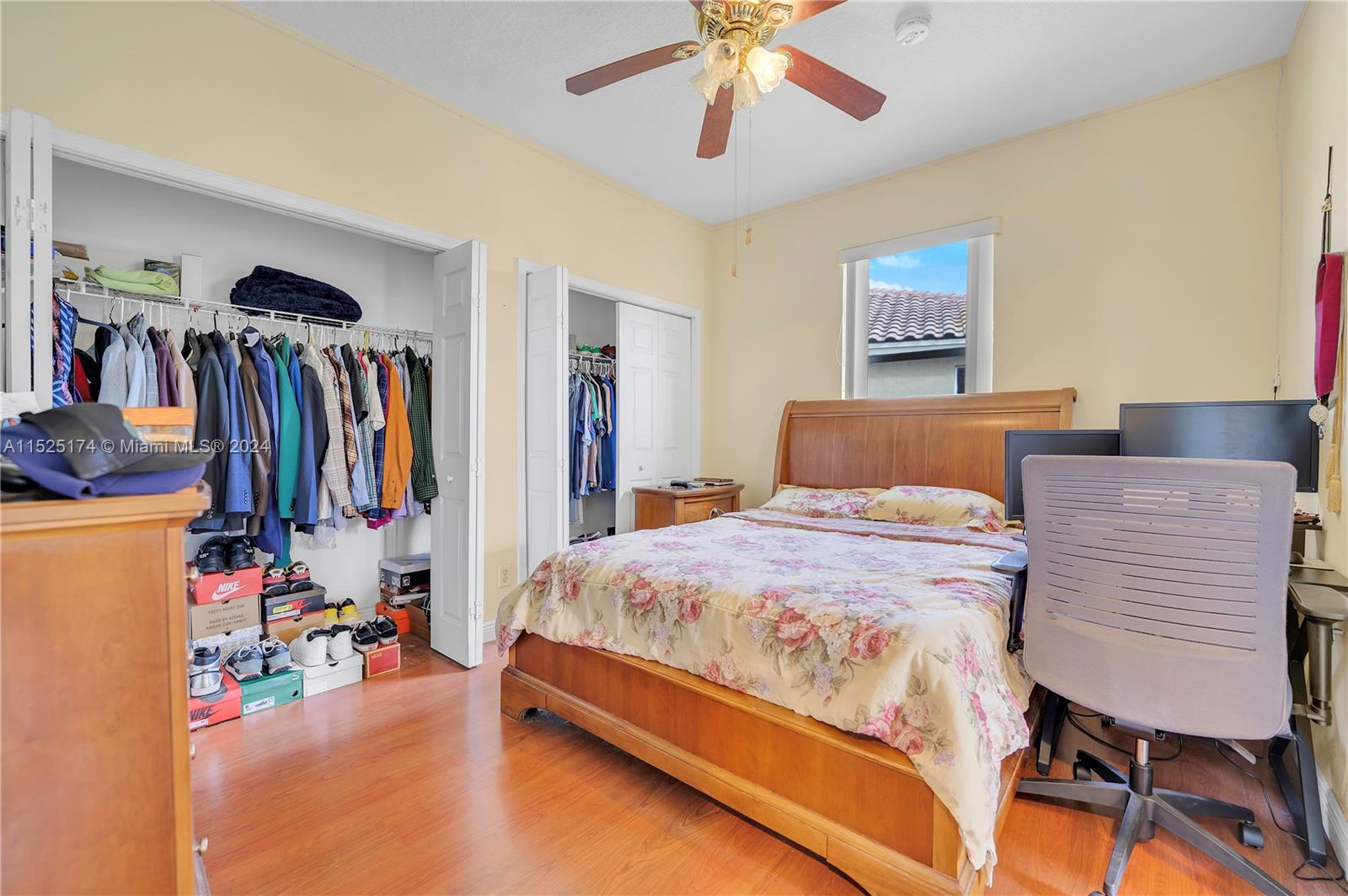 14093 Southwest 53rd Street Miramar, FL 33027 - Photo 37 of 45 a bedroom with a bed and a walk in closet