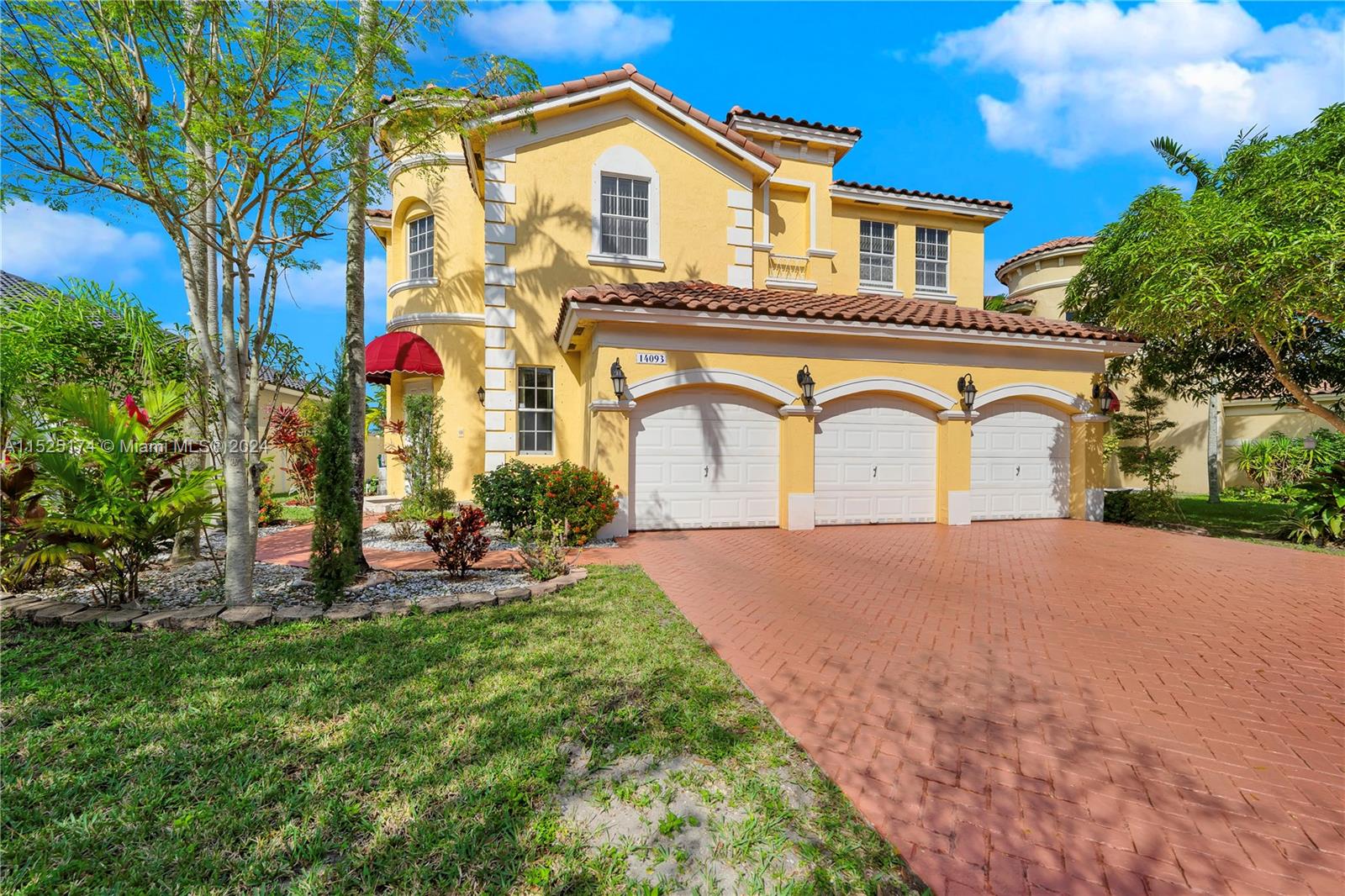 14093 Southwest 53rd Street Miramar, FL 33027 - Photo 44 of 45 a front view of a house with a yard and garage
