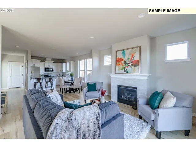 a living room with furniture a fireplace and a window