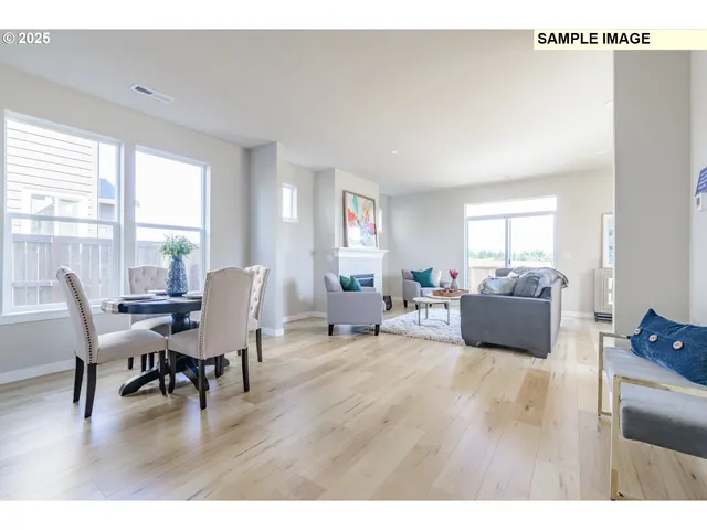 a living room with furniture a dining table and a large window with wooden floor