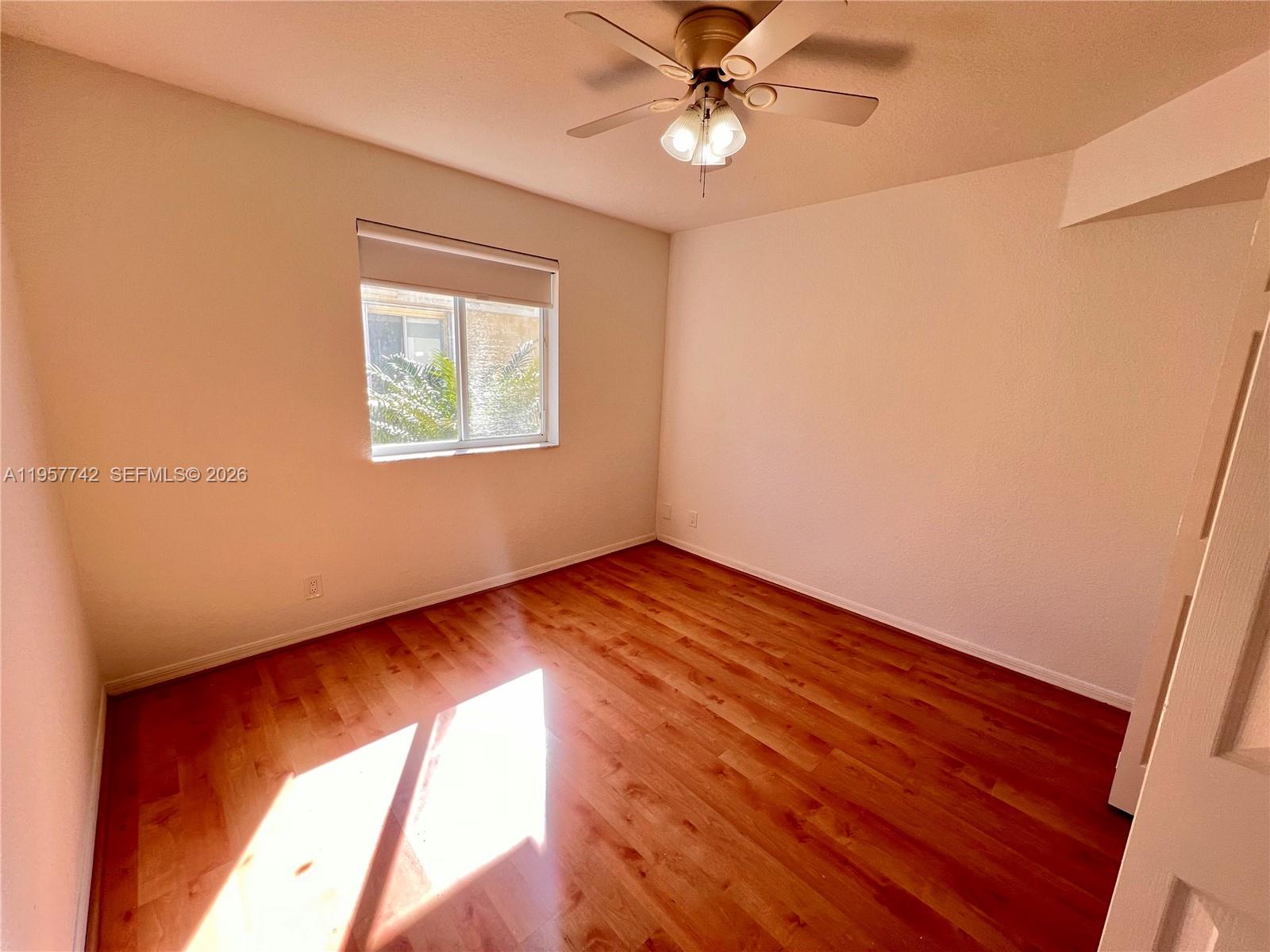 2433 Pasadena Way Weston, FL 33327 - Photo 13 of 20 an empty room with wooden floor fan and windows