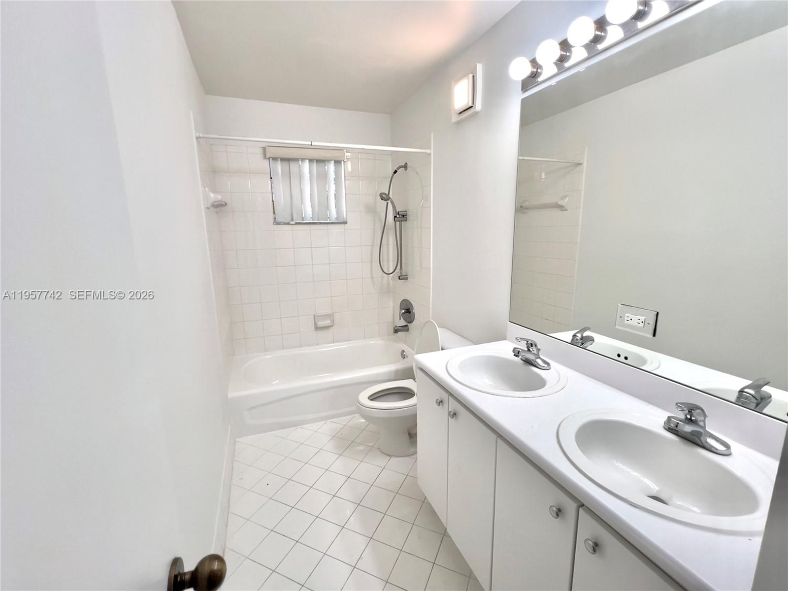 2433 Pasadena Way Weston, FL 33327 - Photo 15 of 20 a bathroom with a sink a toilet and shower