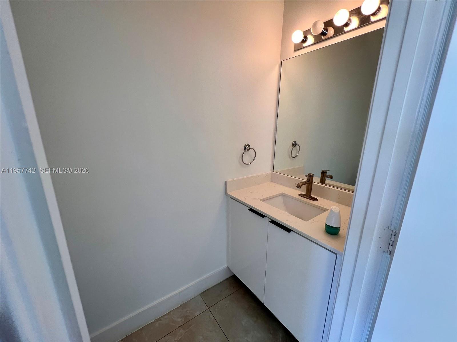 2433 Pasadena Way Weston, FL 33327 - Photo 5 of 20 a bathroom with a sink and mirror