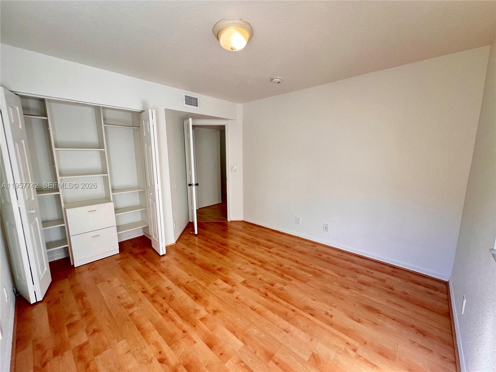 2433 Pasadena Way Weston, FL 33327 - Photo 9 of 20 a view of empty room with wooden floor