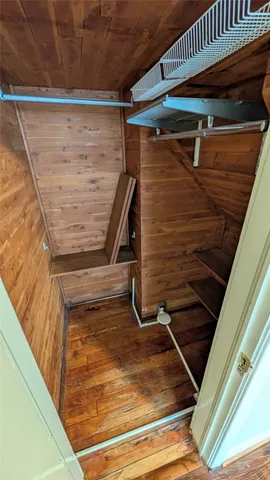 an empty room with wooden floor and a window