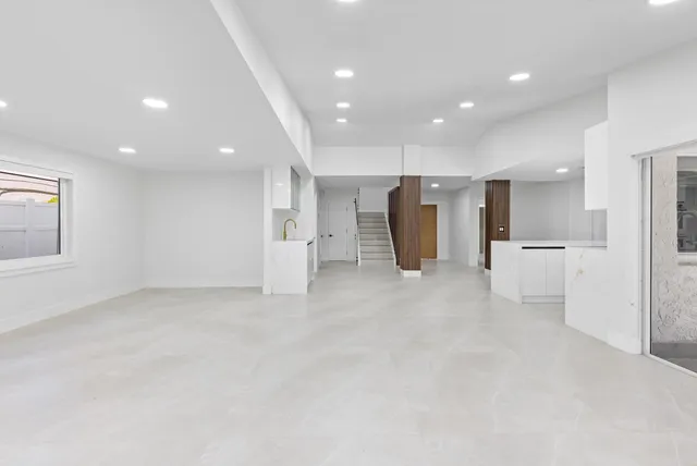 a kitchen with white cabinets and white appliances