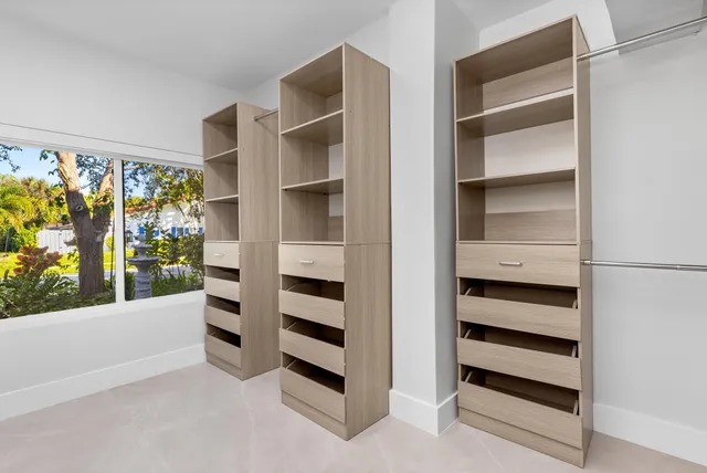 a bathroom with a granite countertop sink a mirror a shower and a bathtub