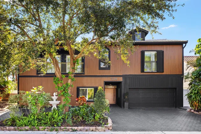 a view of a big room with stainless steel appliances kitchen island large windows and refrigerator