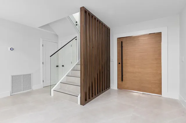a kitchen with granite countertop white cabinets and stainless steel appliances