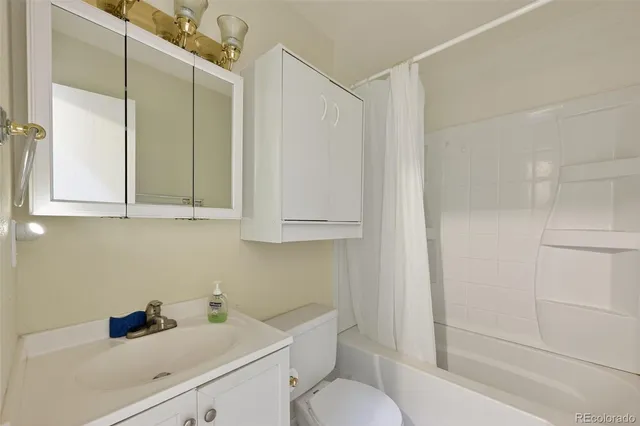 a bathroom with a sink toilet and tub