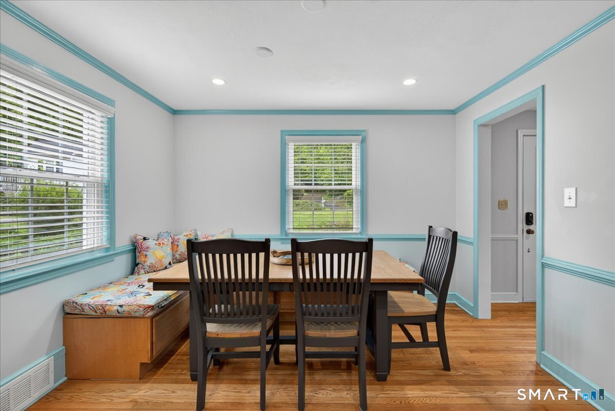 1006 King Road Cheshire, CT 06410 - Photo 7 of 40 The Dining Area includes custom benches with storage, and the dining table and chairs convey with the home.