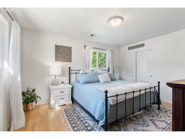 a bedroom with a bed and a night stand