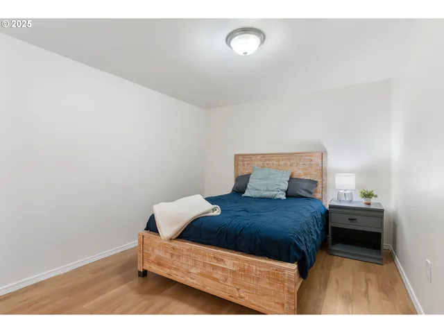 a bedroom with a bed and a lamp