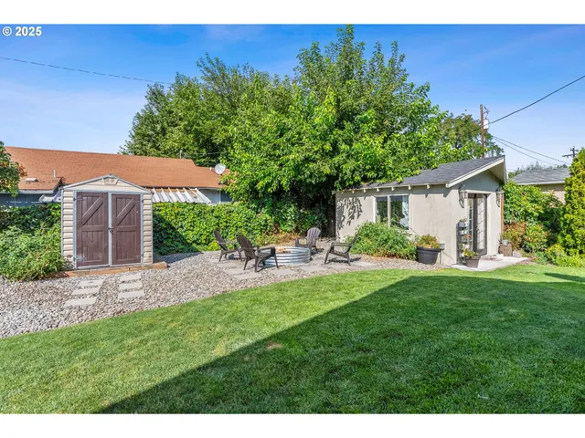 a view of a backyard with plants and a patio