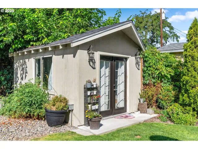 a view of a patio with table and chairs and potted plants